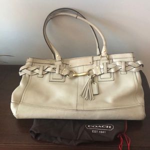 Cream colored leather coach purse with dust cover